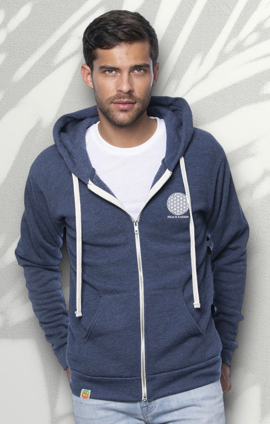 male wearing a blue hood made out of organic cotton and recycled materials. The front of the hoodies has a flower of life logo with the worlds peace nation in white water based ink. The back of the hoodies has a large flower of life design in water based ink. 